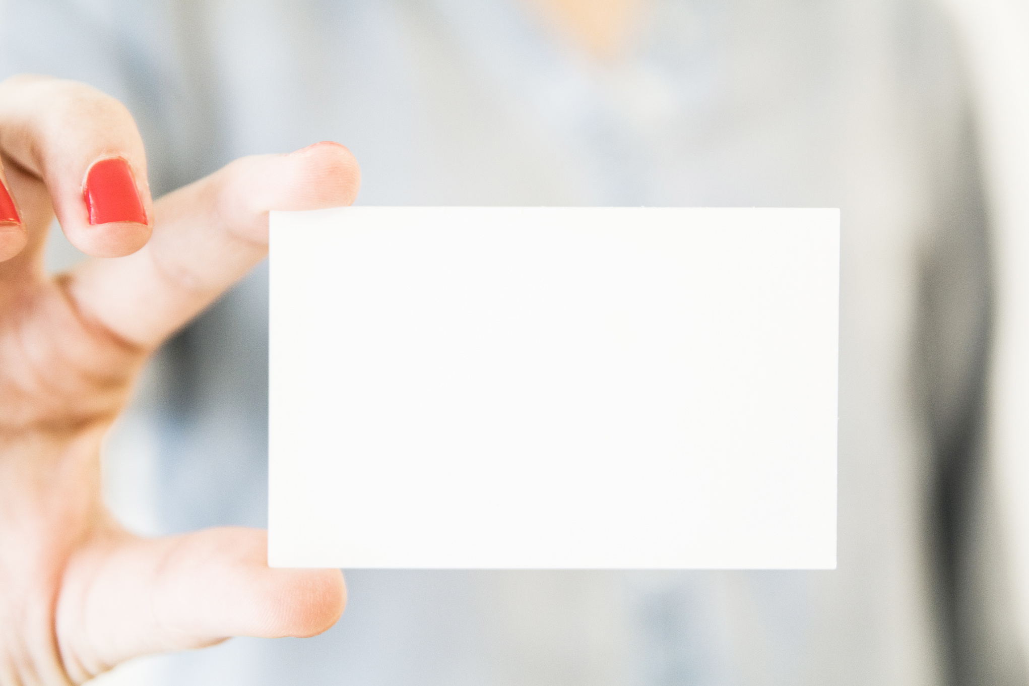 Woman holding white business card mockup